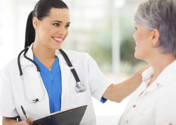 female doctor comforting middle aged patient